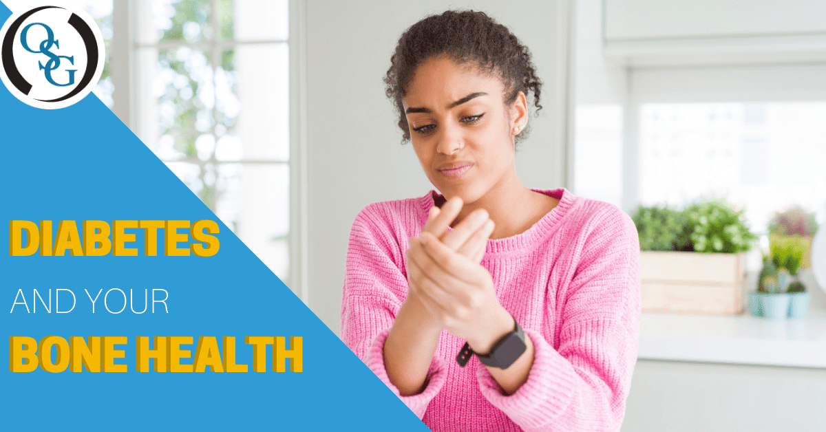 african american woman in pink sweater holding her hand in pain wearing a smart watch