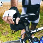 Cyclist with their gloved hand on the bike's seat