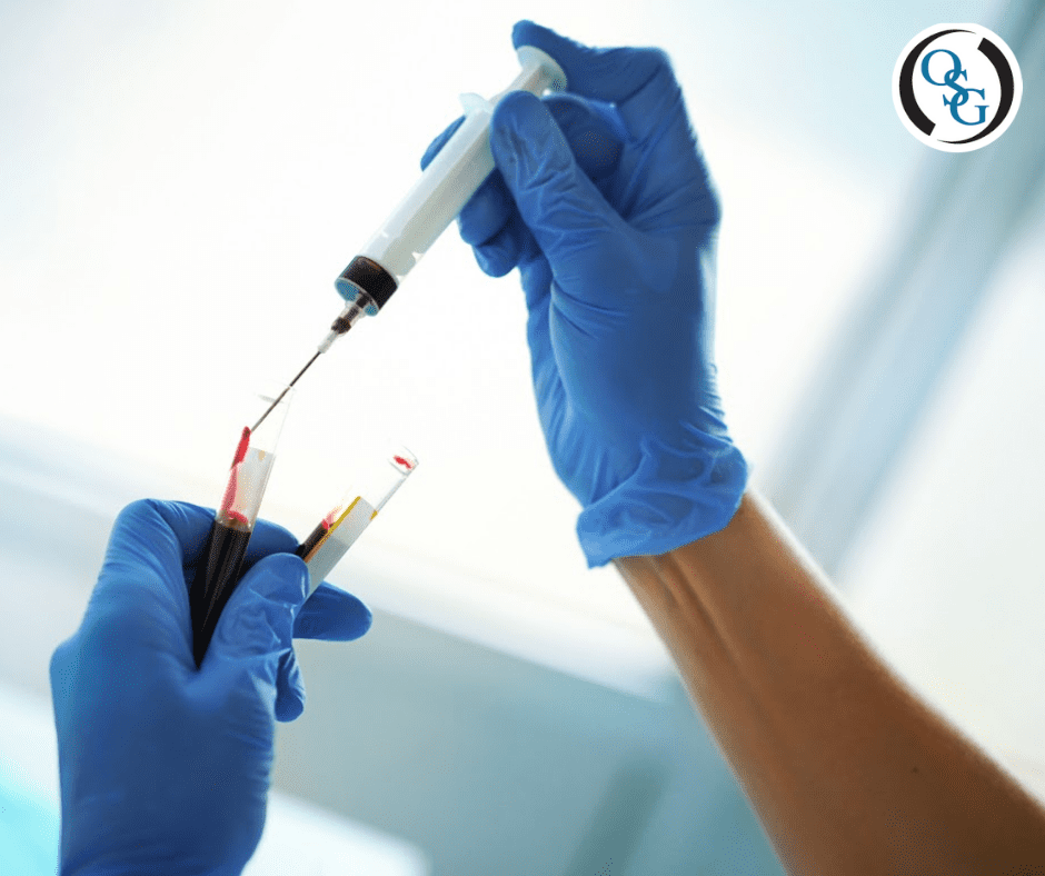Medical professional in gloves with test tubes of blood