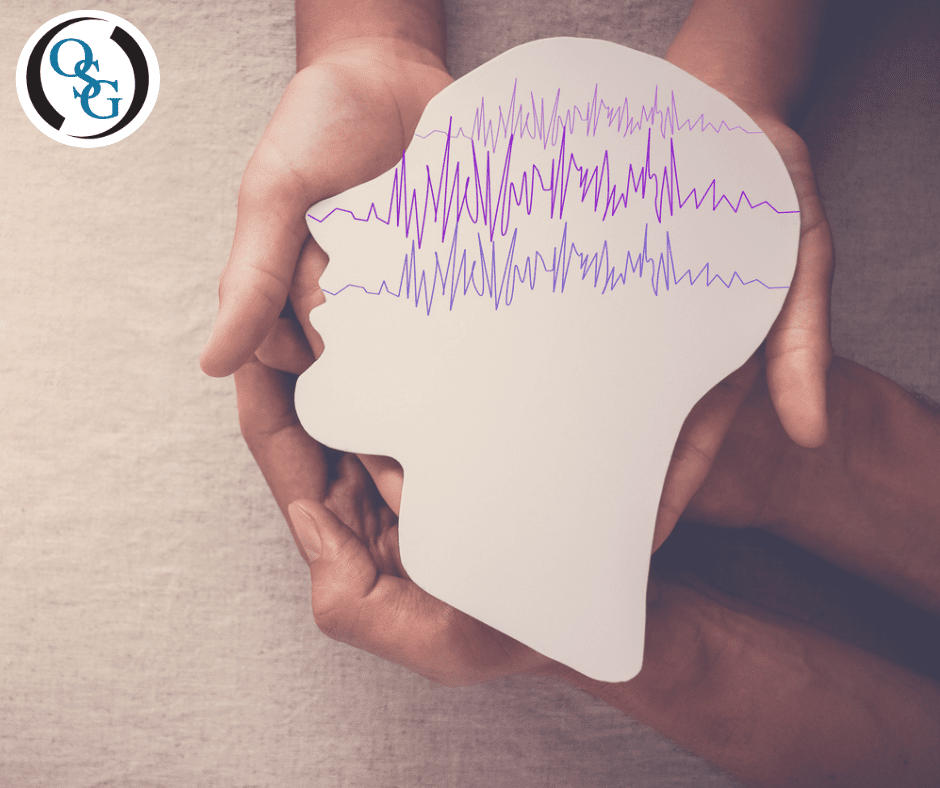 Brain waves drawn on a cut out piece of paper of a human head for epilepsy awareness