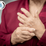 A woman grasping at her hands with rheumatoid arthritis