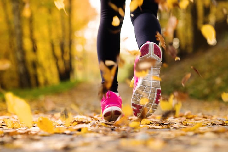 closeup of a woman's running sneakers outside during the fall season