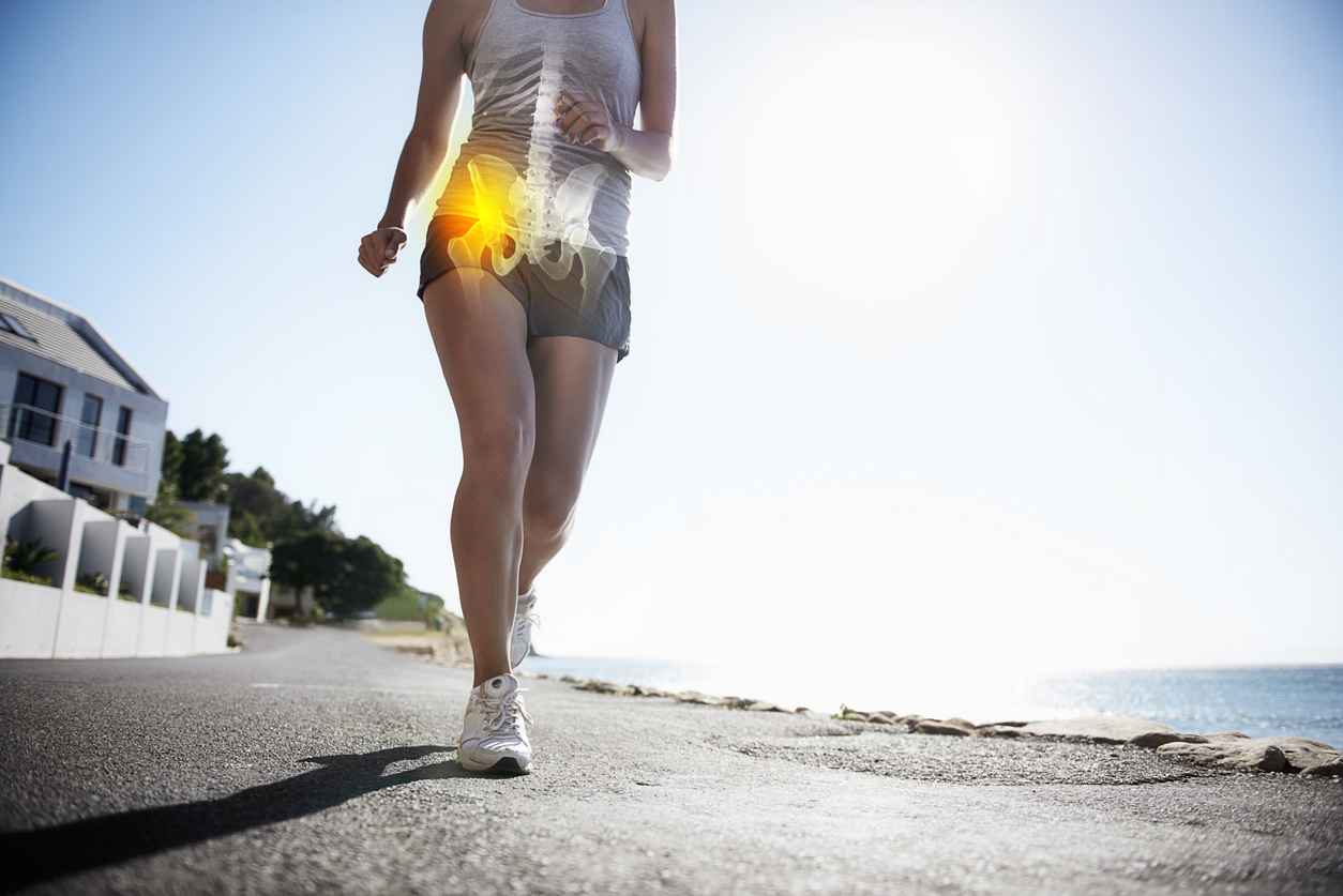 A cropped view of a female jogger on the road experiencing joint inflammation, tips for reducing joint symptoms and tips for joint health
