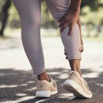 Shot of a woman massaging an injury in her leg; arthritis and nutri