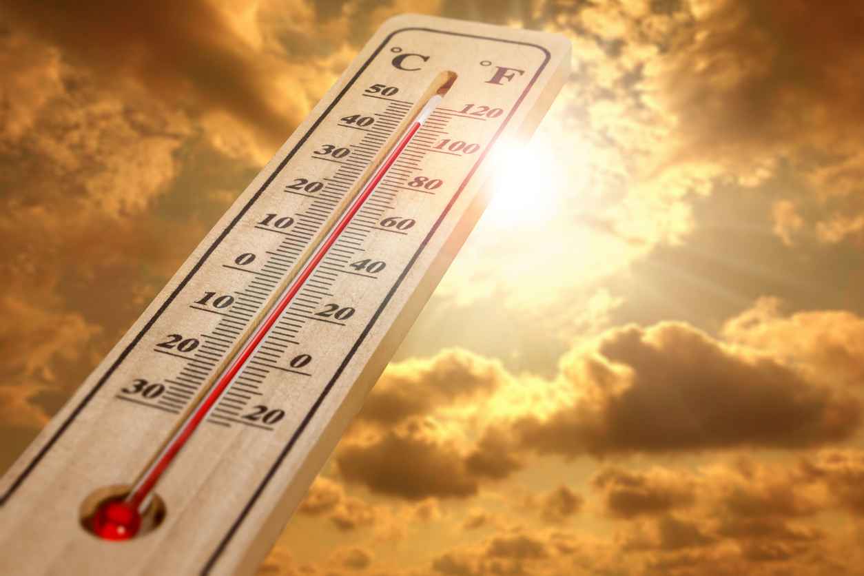 Wood thermometer showing air temperature on a hot sunny day; Understanding Heat-Related Illnesses